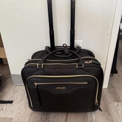 Sale Photo Thumbnail #47: Black rolling travel case with gold zippers, ideal for business or overnight trips.