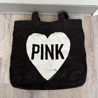 Sale Photo Thumbnail #48: Black canvas tote with bold “PINK” heart design, casual and lightweight.