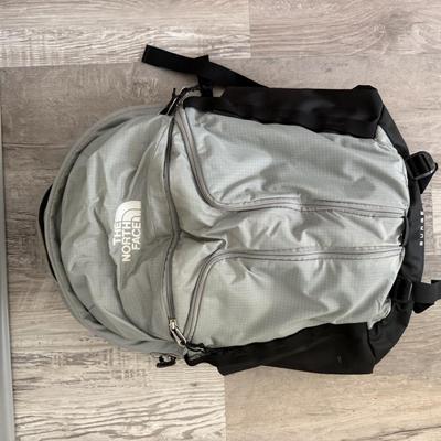 Sale Photo Thumbnail #51: Durable gray and black backpack with multiple compartments, built for travel, school, or outdoor use