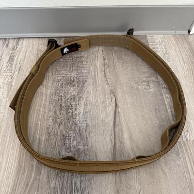 Sale Photo Thumbnail #57: Tan nylon tactical belt with heavy-duty buckle, strong and adjustable for outdoor or work use.