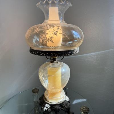 Sale Photo Thumbnail #66: Elegant hurricane-style lamp with etched floral glass globe and detailed cast metal base. A beautiful accent piece with warm vintage charm.