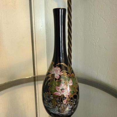 Sale Photo Thumbnail #80: Tall black porcelain vase with delicate hand-painted lotus flowers in pink and green, highlighted with metallic gold details.
