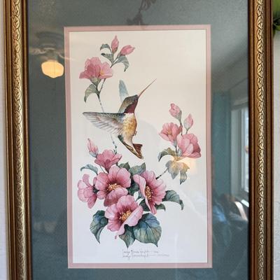 Sale Photo Thumbnail #99: Bright and cheerful print featuring a hummingbird hovering near pink blossoms. Matted with a green and pink border, framed in gold-tone frame. Signed and numbered limited edition.
