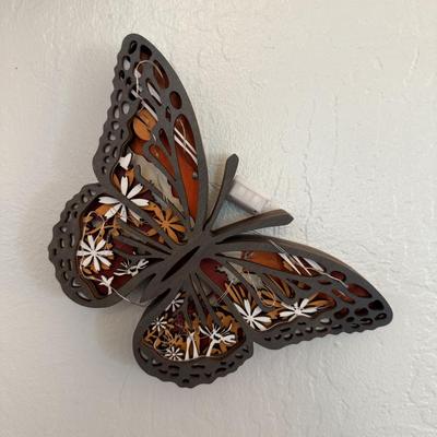 Sale Photo Thumbnail #101: Decorative butterfly wall hanging with cutout design and floral inlay detail.