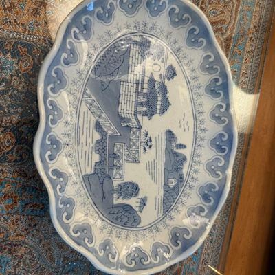 Sale Photo Thumbnail #111: Scalloped-edge porcelain platter with traditional blue-and-white landscape design.
