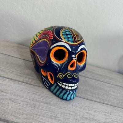 Sale Photo Thumbnail #139: Colorful ceramic skull with bold hand-painted details, traditional Dia de los Muertos style.