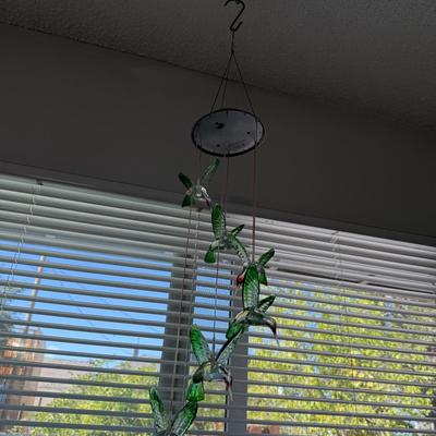 Sale Photo Thumbnail #169: Delicate hanging mobile with green glass hummingbirds, perfect for catching light near a window or adding a whimsical touch to any indoor or outdoor space.