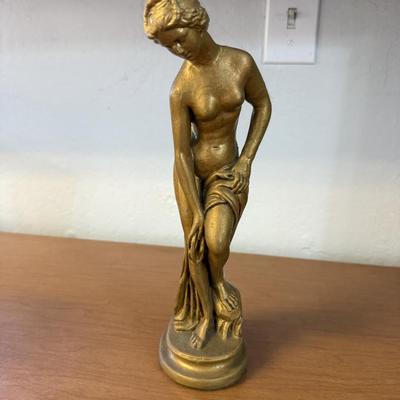 Sale Photo Thumbnail #182: Graceful gold-tone statue of a classical female figure with fine detail and timeless elegance. Ideal as a decorative accent or art display.