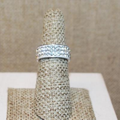 Size 6 Infinity Style Ring on a Silver Tone Band with 3 Rows of Clear Stones (3.7g)