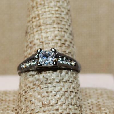 Size 10 High Rise Azure Cut 4 Prong Clear Main Stone & Side Accents on a BLACK Tone Band (2.6g)