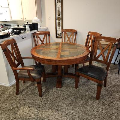 Sale Photo Thumbnail #5: Sturdy dining room table with 5 chairs and a leaf. Clean and ready for your next gathering.