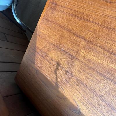 Sale Photo Thumbnail #107: Not Veneer. Solid Top. 47” long x 25 1/2” wide x 16” tall. Ring / Stain in one corner. Could be removed. All pieces are solid teak. Stamped Denmark on bottom. Unknown maker