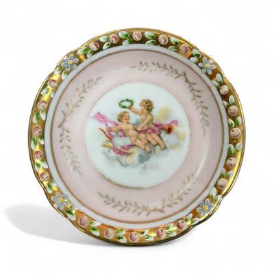 Sale Photo Thumbnail #653: Lenwile Ardalt Cherub Trinket Dishes Set of 2 One Yellow and One Pink
 Porcelain often hand painted and adorned with gold accents and raised floral designs and were imported from Japan