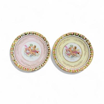 Sale Photo Thumbnail #655: Lenwile Ardalt Cherub Trinket Dishes Set of 2 One Yellow and One Pink
 Porcelain often hand painted and adorned with gold accents and raised floral designs and were imported from Japan
