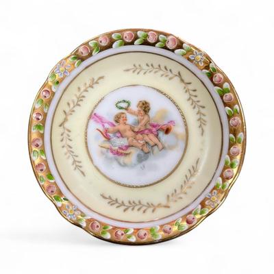 Sale Photo Thumbnail #654: Lenwile Ardalt Cherub Trinket Dishes Set of 2 One Yellow and One Pink
 Porcelain often hand painted and adorned with gold accents and raised floral designs and were imported from Japan