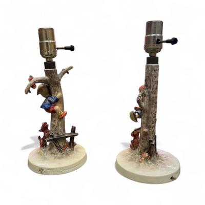 Sale Photo Thumbnail #659: Goebel Hummel L Lamp Set Boy and Girl in the Apple Tree  Hum 56/A Culprits and Hum 56?B  1970's  In working condition  No Lamp Shades   12" Tall One dog ear on boy lamp broken off.