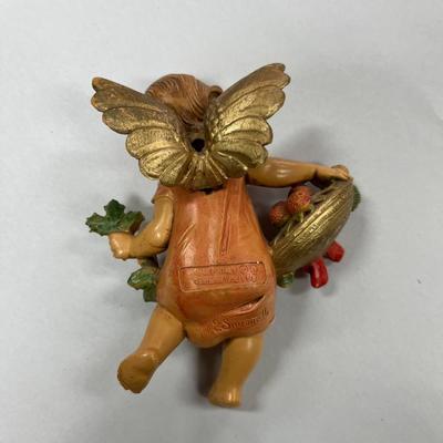 Sale Photo Thumbnail #676: Fontanini Simonelli Cherub angel with Fruit, Holly and Pine Cones.  Approximately 4.5" tall
