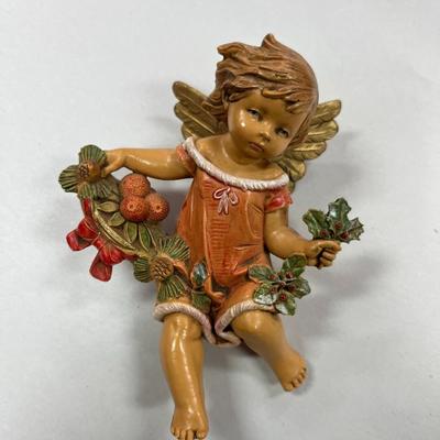 Sale Photo Thumbnail #677: Fontanini Simonelli Cherub angel with Fruit, Holly and Pine Cones.  Approximately 4.5" tall
