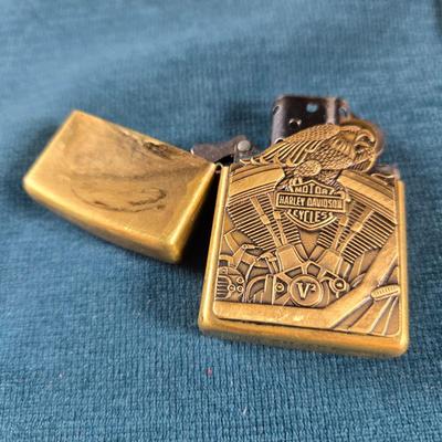 Sale Photo Thumbnail #32: This auction lot is for a newer Brass Harley Davidson Zippo Lighter.  It is marked F XV on the bottom.  Great design and appears in very good shape.  Made in USA - Bradford, PA.  Great gift idea.