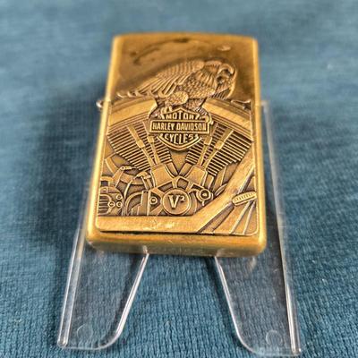Sale Photo Thumbnail #30: This auction lot is for a newer Brass Harley Davidson Zippo Lighter.  It is marked F XV on the bottom.  Great design and appears in very good shape.  Made in USA - Bradford, PA.  Great gift idea.