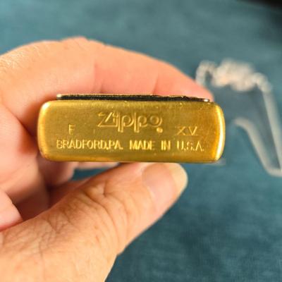 Sale Photo Thumbnail #34: This auction lot is for a newer Brass Harley Davidson Zippo Lighter.  It is marked F XV on the bottom.  Great design and appears in very good shape.  Made in USA - Bradford, PA.  Great gift idea.