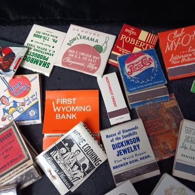 A COLLECTION OF MATCHBOOKS AND FAKE CIGARS
