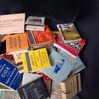 A COLLECTION OF MATCHBOOKS AND FAKE CIGARS
