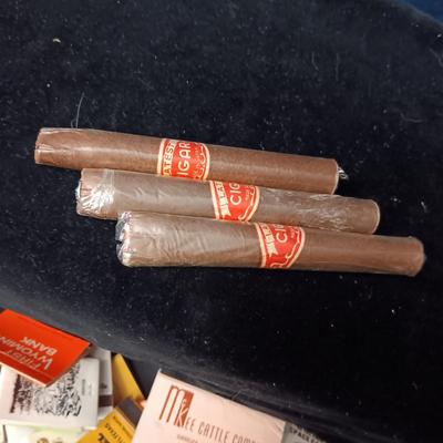 A COLLECTION OF MATCHBOOKS AND FAKE CIGARS