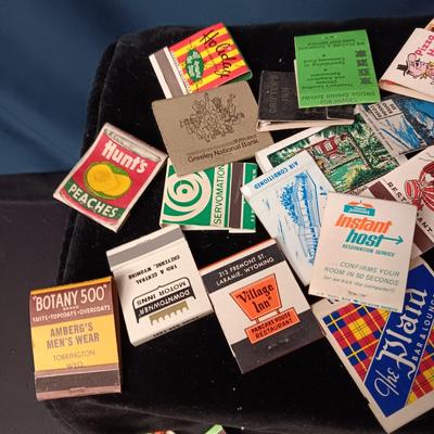 A COLLECTION OF MATCHBOOKS AND FAKE CIGARS