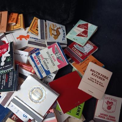 A COLLECTION OF MATCHBOOKS AND FAKE CIGARS