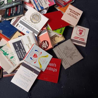 A COLLECTION OF MATCHBOOKS AND FAKE CIGARS