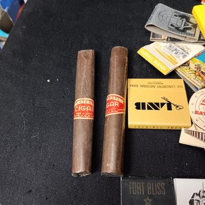 A COLLECTION OF MATCHBOOKS AND FAKE CIGARS