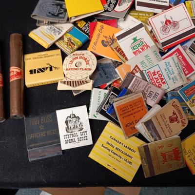 A COLLECTION OF MATCHBOOKS AND FAKE CIGARS
