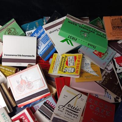 A COLLECTION OF MATCHBOOKS AND FAKE CIGARS