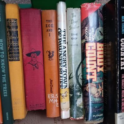 BOOKS AND A PLASTIC MILK CRRATE
