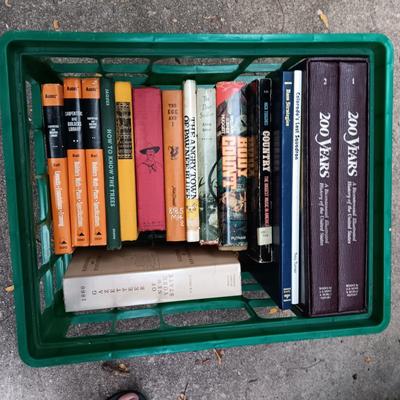 BOOKS AND A PLASTIC MILK CRRATE