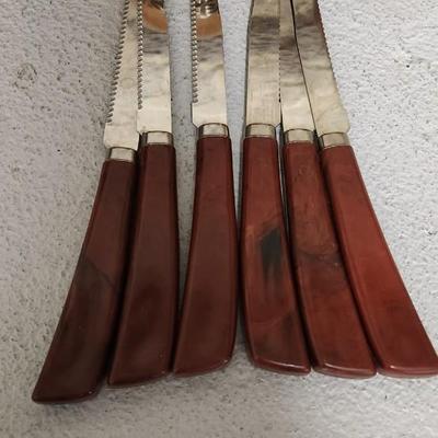 Sale Photo Thumbnail #390: Neat set of vintage steak knives and 4 vintage hand carved totem mugs.