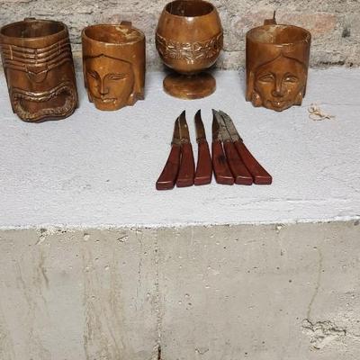 Sale Photo Thumbnail #389: Neat set of vintage steak knives and 4 vintage hand carved totem mugs.