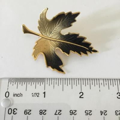Maple leaf brooch, black and gold 1970s brooch