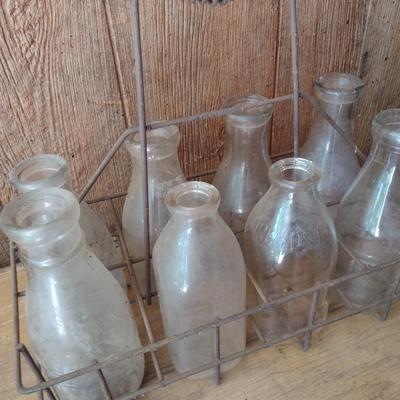 Set of Eight Vintage Dairy Milk Bottles Various Markings in Metal Wire Carry Caddy (#40)