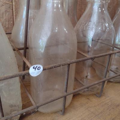 Set of Eight Vintage Dairy Milk Bottles Various Markings in Metal Wire Carry Caddy (#40)