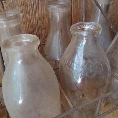 Set of Eight Vintage Dairy Milk Bottles Various Markings in Metal Wire Carry Caddy (#40)