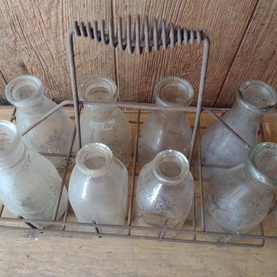 Set of Eight Vintage Dairy Milk Bottles Various Markings in Metal Wire Carry Caddy (#40)