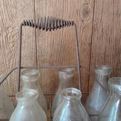 Set of Eight Vintage Dairy Milk Bottles Various Markings in Metal Wire Carry Caddy (#40)