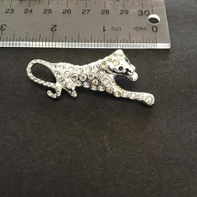 Sale Photo Thumbnail #150: Silvertone panther lapel pin with rhinestones. Please see attached photos.