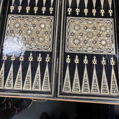 Sale Photo Thumbnail #845: Mosaic style inlaid Chess Set with Mother of Pearl.  The set includes 32 chess pieces, divided into dark and light colors.  One piece is broken (See Photo).  Has Backgammon on the flip side.