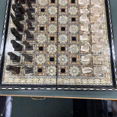 Sale Photo Thumbnail #844: Mosaic style inlaid Chess Set with Mother of Pearl.  The set includes 32 chess pieces, divided into dark and light colors.  One piece is broken (See Photo).  Has Backgammon on the flip side.
