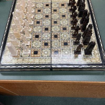 Sale Photo Thumbnail #840: Mosaic style inlaid Chess Set with Mother of Pearl.  The set includes 32 chess pieces, divided into dark and light colors.  One piece is broken (See Photo).  Has Backgammon on the flip side.