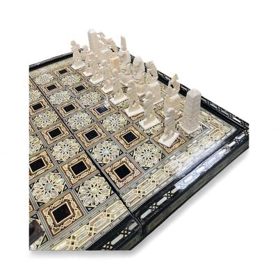 Sale Photo Thumbnail #843: Mosaic style inlaid Chess Set with Mother of Pearl.  The set includes 32 chess pieces, divided into dark and light colors.  One piece is broken (See Photo).  Has Backgammon on the flip side.