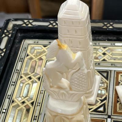 Sale Photo Thumbnail #839: Mosaic style inlaid Chess Set with Mother of Pearl.  The set includes 32 chess pieces, divided into dark and light colors.  One piece is broken (See Photo).  Has Backgammon on the flip side.